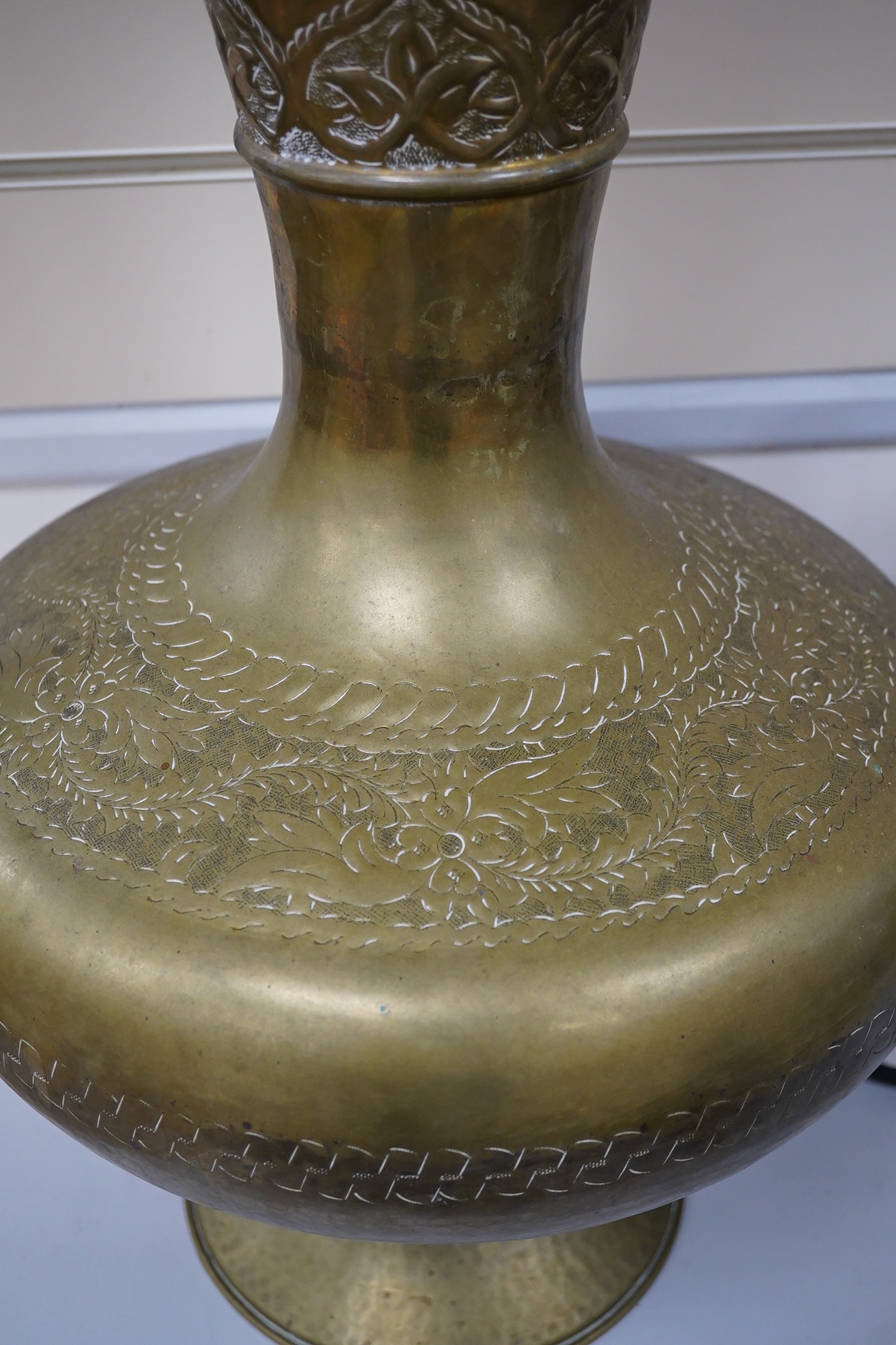 A large Indian brass ewer, 73cm tall. Condition - fair to good